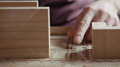 Hands of Professional Man Constructing Architecture Model of Urban City Building