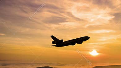 Plane takes off at sunrise