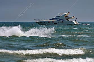 Seascape with boat on the sea. Waves show. Summer, sun, beach, holiday, fun and blue sky - Black Sea, landmark attraction, Romania