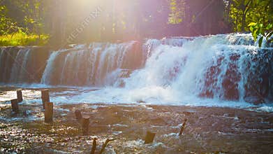 Panorama the waterfall and the ruins of a wooden bridge in the forests of Cambodia