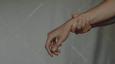 Person holding painful wrist suffering from carpal tunnel syndrome