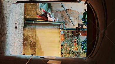 Arched passageway in ancient building with view of courtyard decorated with