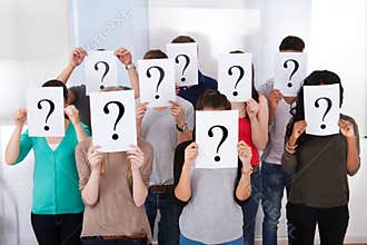 University students holding question mark signs
