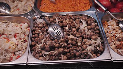 Fresh marinated mushrooms in a buffet tray.