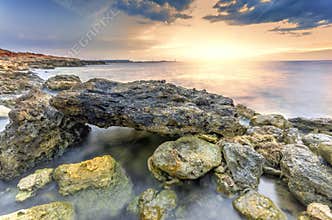 Surreal landscape heap of stones in the sea shot with a long exp