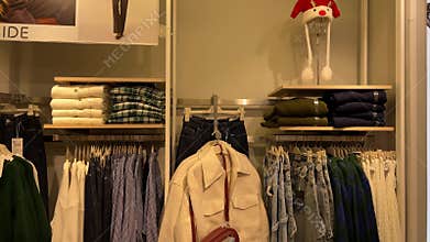 Christmas fashion store displaying seasonal clothing and accessories against a wall background
