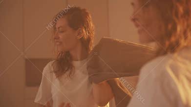 Young adult Happy woman wrapped in towel drying blonde hair with towel after shower. smiling face girl wiping blotting