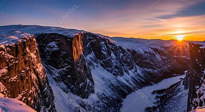 Snow covered mountain valley at sunset with dramatic cliffs image