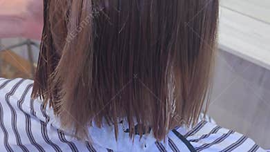 Trimming the ends of hair with scissors. Hairdressing at a beauty salon