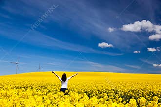 Happy young woman on spring field, ecology