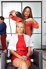 Barbershop. Woman haircut. Use of hair dryer.