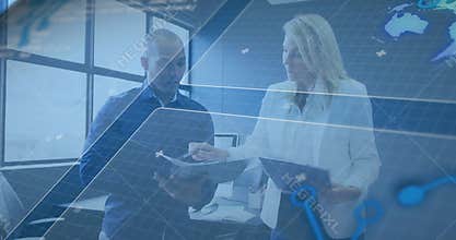 Business team reviewing documents, woman pointing pen initiating blue map overlay highlighting data