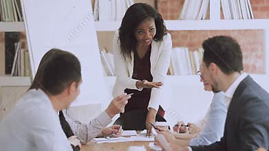 Happy mixed race employees enjoying brainstorming meeting.
