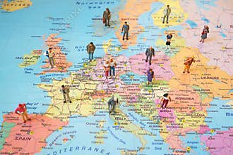 Many figures of people are placed on Europe map.