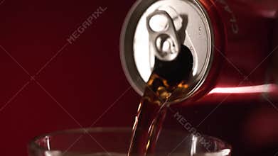 Moscow, Russia - 14 04 2020: Rack focus coca cola pouring in a glass with ice cubes on red background slow motion