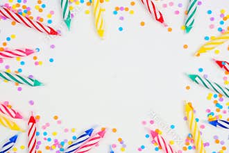 Birthday cake candles with candy sprinkles. Frame on a white background.