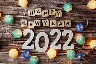 Happy New Year 2022 decorate with LED cotton ball on wooden background