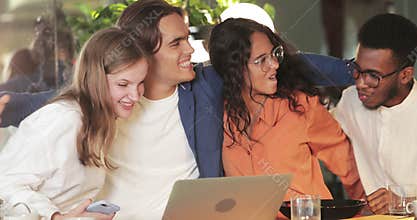 Young happy coworkers having good news and celebrating success .Millennial startupers making yes gesture and smiling