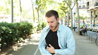 Man suffering stomach ache in the street