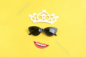 Hello summer The sun with stylish black sunglasses, smiling mouth on yellow background