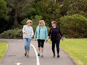 Happy active senior citizen women walking and training together in healthy retirement lifestyle