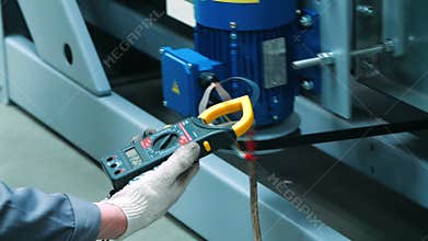 Engineer holding in hand multimeter professional multifunctional manual device