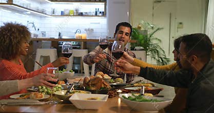 Millennial adult friends celebrating Thanksgiving together at home