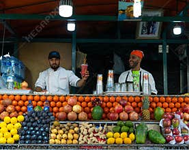 Marrakech, Morocco - 15 JAN 2019: Two happy arabic Fruit fresh juice sellers on Jemma El Fna square in Marrakesh