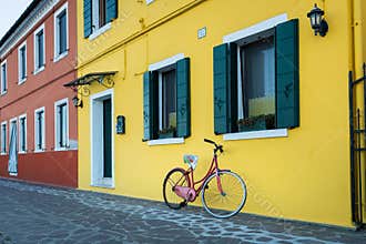 Bicycle in front of a yellow house in Burano