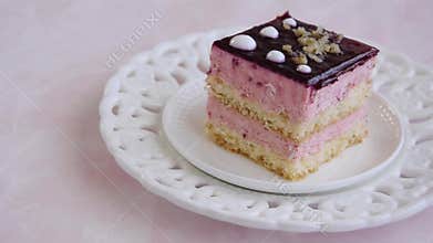 Yummy slice of strawberry cake on pink background, creamy dessert