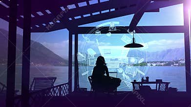 A writer works on a laptop after sunset.