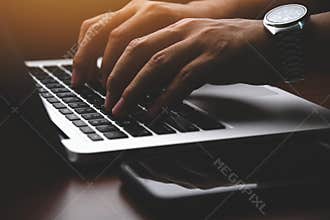 Businessman hands working and typing on laptop keyboard
