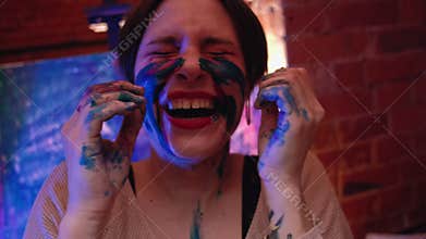 Creative madness joyful woman face paint laughing