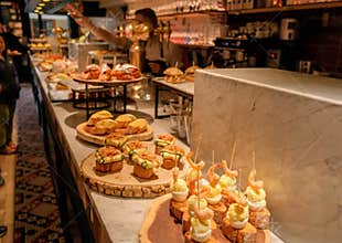 Traditional Spanish snacks or tapas called pintxos in a bar counter