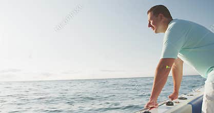 Side view of a Caucasian man on boat enjoying the sea view