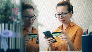 Pretty lady is happy while making an online purchase. Online banking, online payment concept.