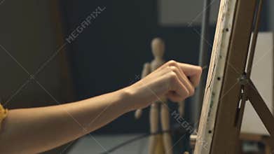 Artist sketching on canvas using charcoal