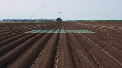 UAV drone, copter with digital camera flies over, scanning newly plowed agricultural field, Smart agriculture. concept