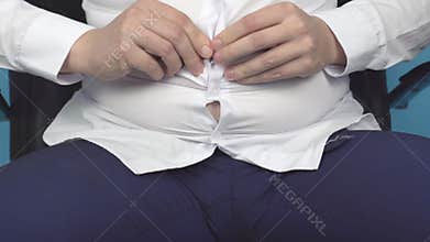 Fat man office worker buttoning a shirt on a fat stomach with wrinkles, excess weight, obesity, unhealthy diet, close-up