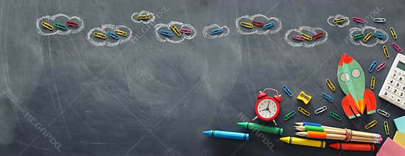 Education. Back to school concept. rocket cut from paper and painted over blackboard background. top view, flat lay. banner