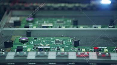Automated SMT machine placing electronic components on a board.