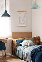 Pastel blue and mint accents in cozy children`s bedroom
