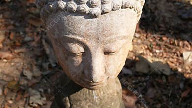 4K. Calm and peaceful face of old worship buddha statue head illuminated. Buddha statue at Chiangmai history temple.