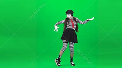 Mime girl is dancing behind an invisible glass. Chroma key.