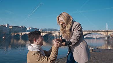 Handsome young man proposing to his girlfriend on pier. Love, family, relationship, wedding concept. Filmed on REd 4k