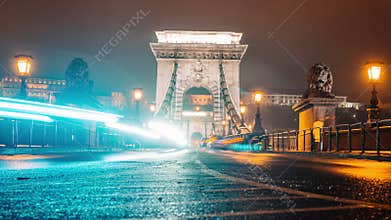 Timelapse view to Chain bridge and city traffic. Beautiful evening or night scene of illuminating ancient architecture.