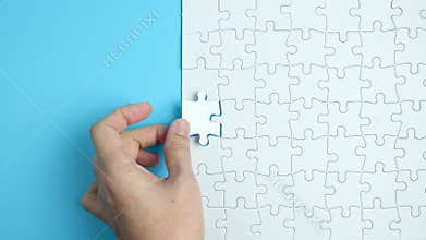 Hand complete the last piece white puzzle for business design