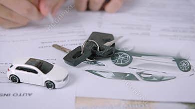 Buyers or sellers who are reading car lease or car insurance contract and signing. Sale agent deal to agreement car loan contract