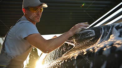 Men Washing His Car with a Sponge