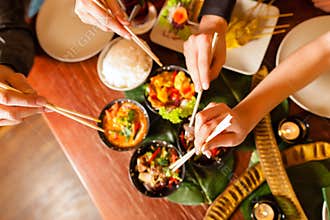 Young people eating in Thai restaurant